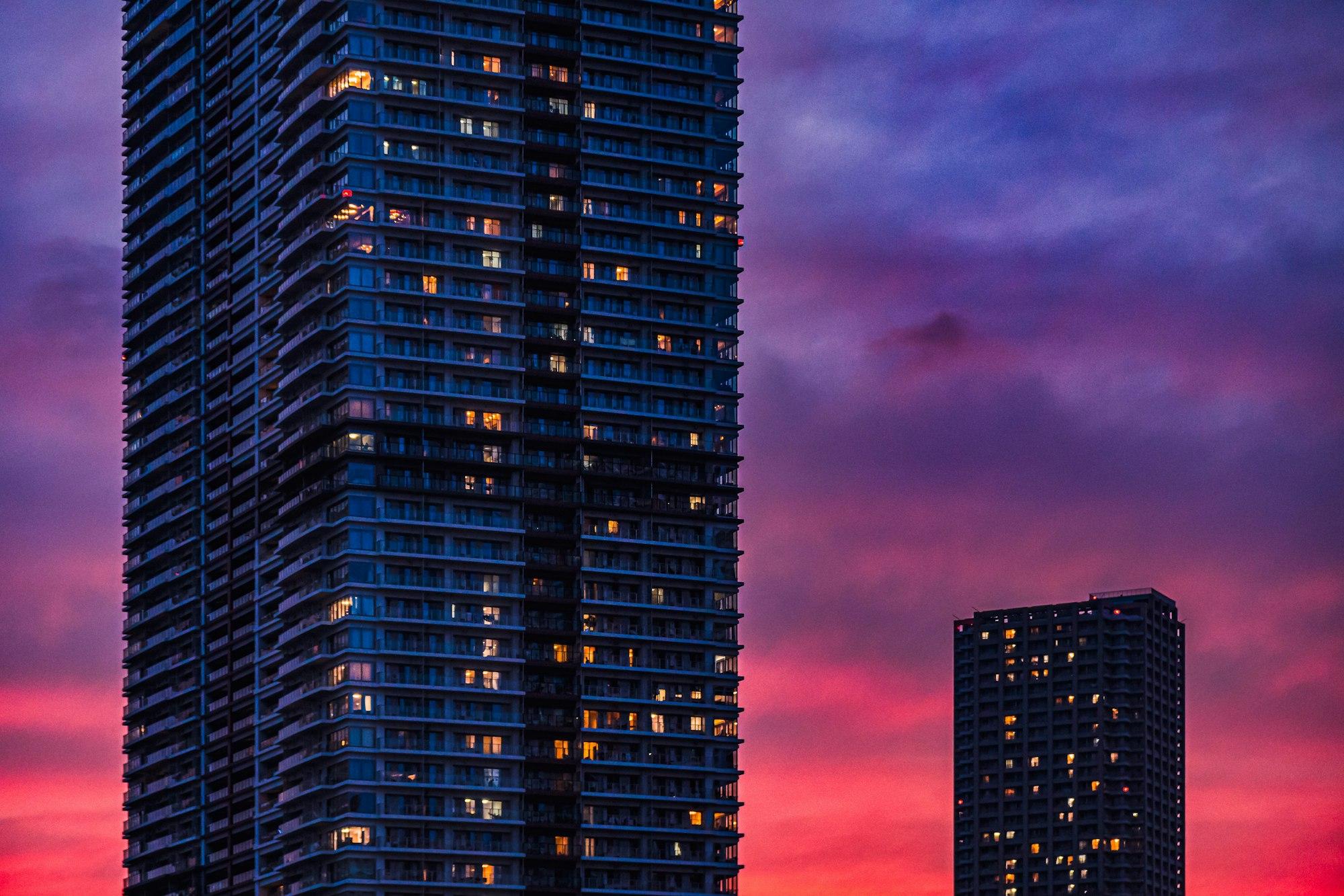 Illuminated luxury high-rise apartment towers at dusk, representative of Lodha Hopefarm Whitefield in Bengaluru