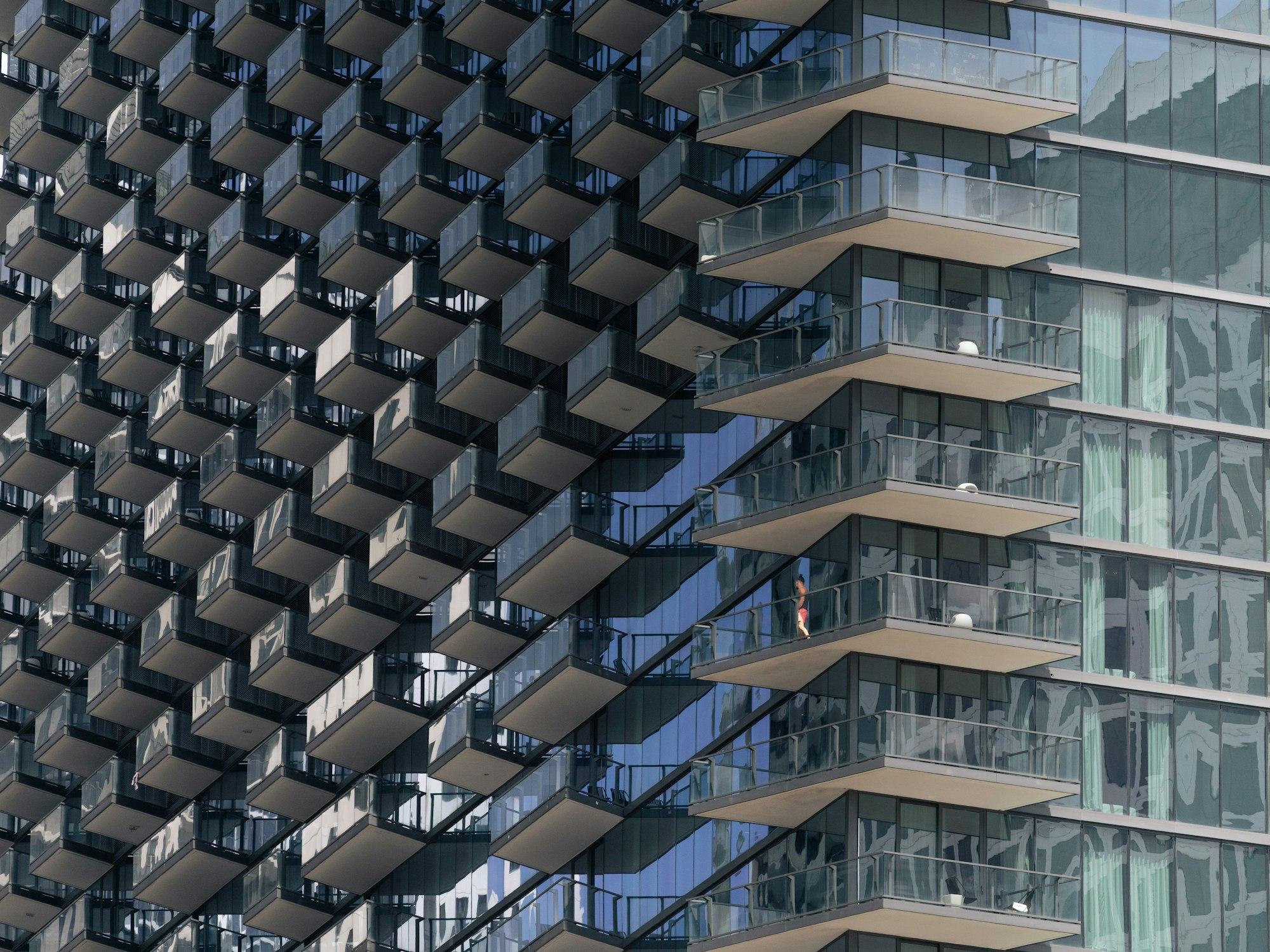 Contemporary residential tower facade with staggered private balconies and floor-to-ceiling glazing
